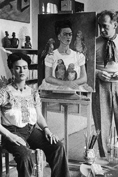 Frida Kahlo posing with a selfportrait